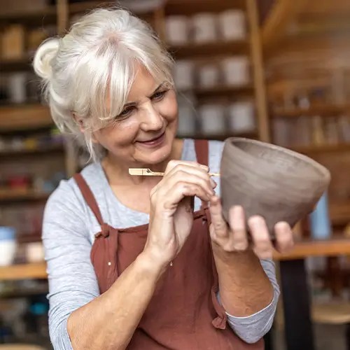 Woman making a clay pot
