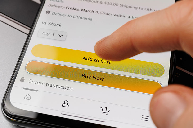 A customer buying something on Amazon, their finger hovering over the add to cart button