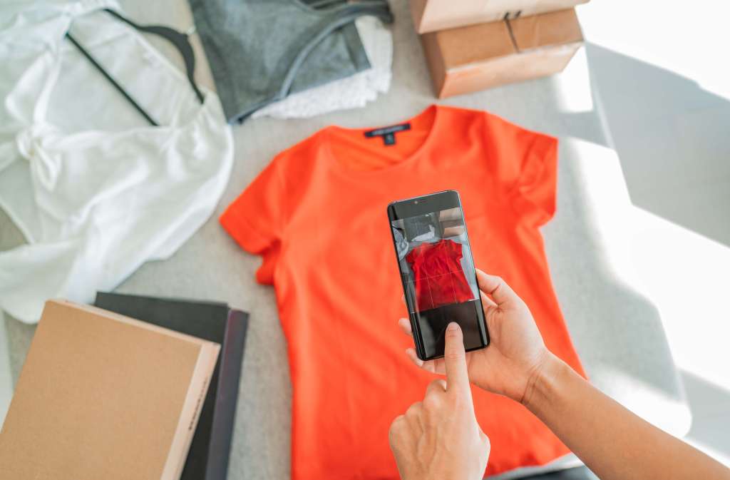 Seller taking a photo of clothing