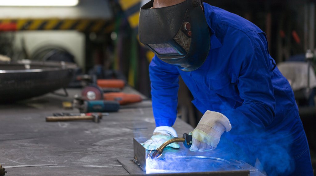 Welder working on metal structure