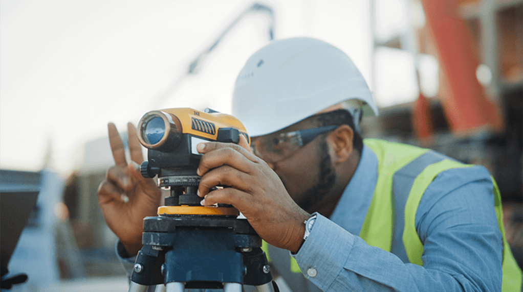Surveyor using theodolite outside
