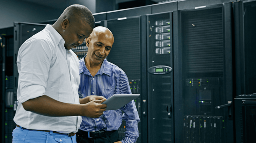 IT consultant checking discussing performance in a server room