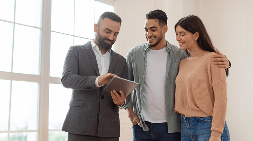 A property agent discussing a house with potential buyers