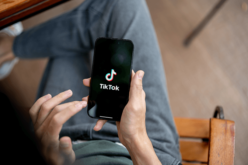 A small business owner goes on TikTok on their phone
